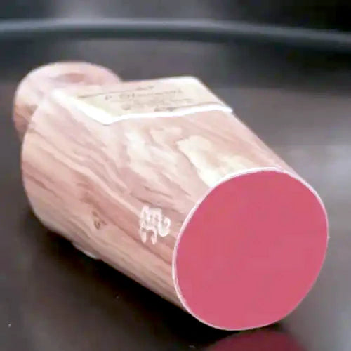 Boselli No. 4 – olive wood perfume flacon laid on its side, red-stained circular base and natural wood grain, made in France | LaPeNu
