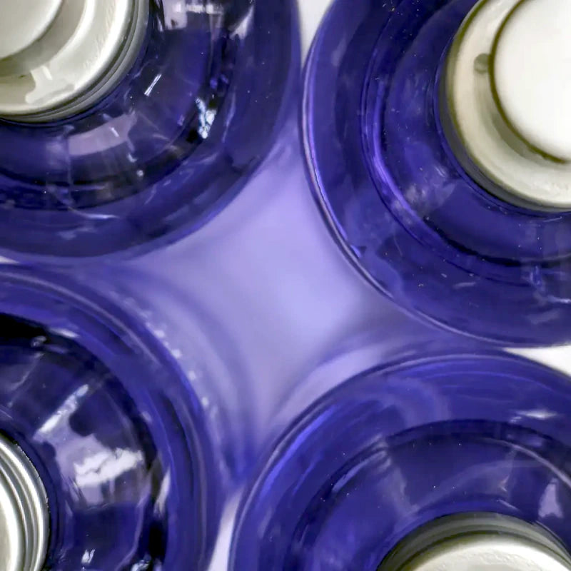 Violet glass spray bottles with fine lavender room fragrance — a few sprays to scent any closed space. Made in France | Lapenu